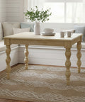 Wooden dining table with decor items in a bright room with white walls and a window.